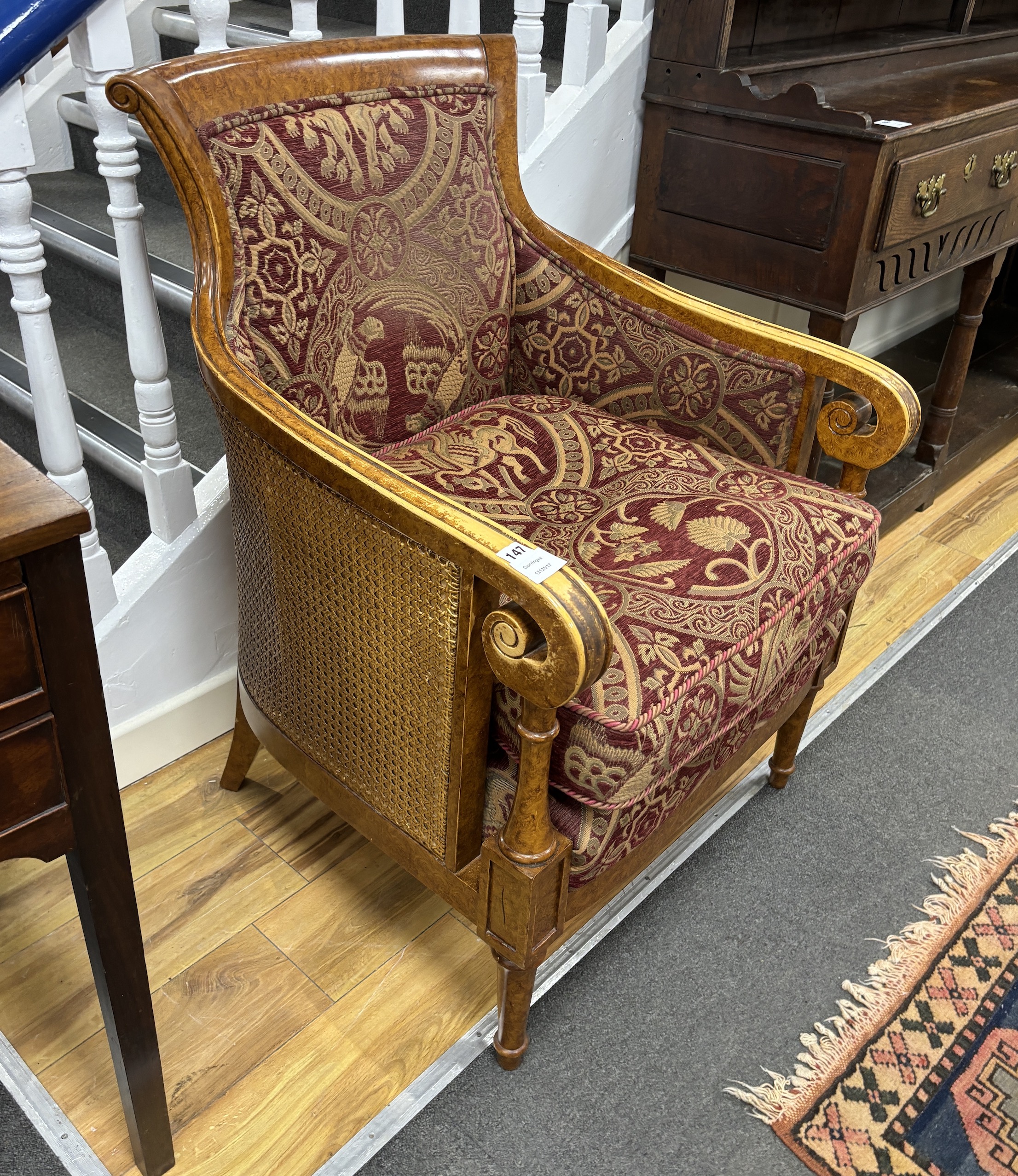 An Empire style bergère armchair, width 67cm, depth 62cm, height 95cm